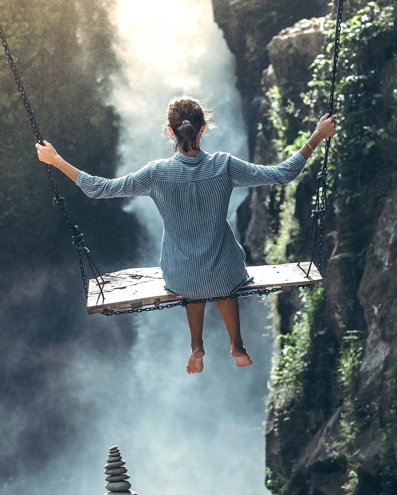 Travel tips for unique adventures with a woman on a swing.