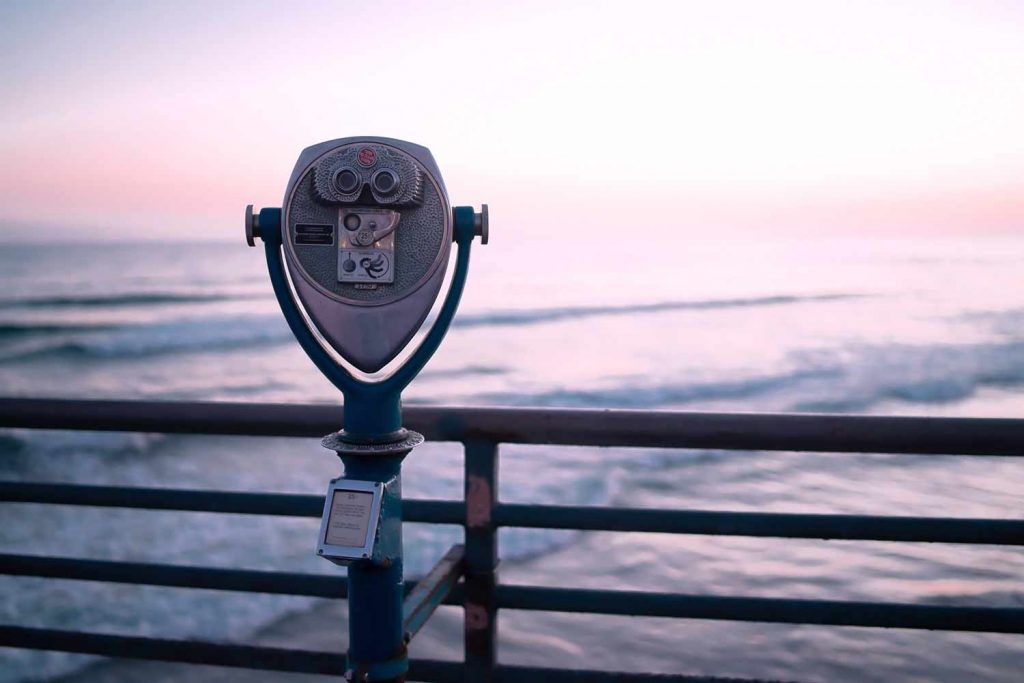 A view finder overlooking the ocean at sunset.