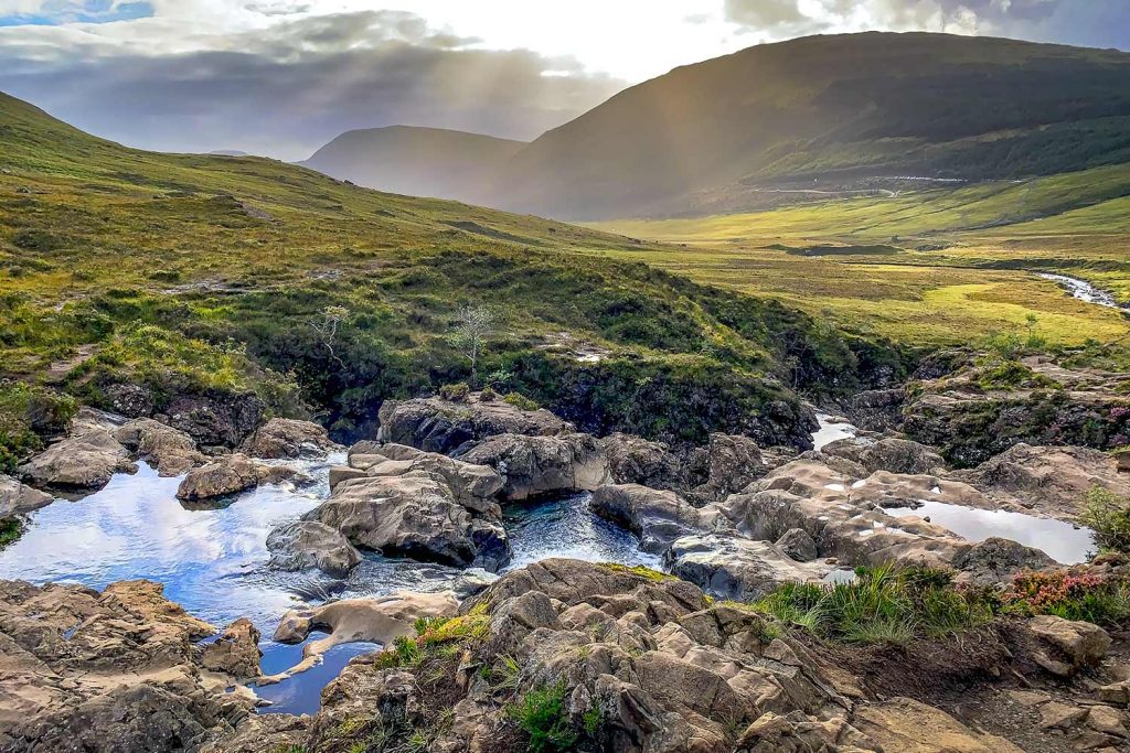Magnificent view of a Highlands valley with fairy pools in the foreground.