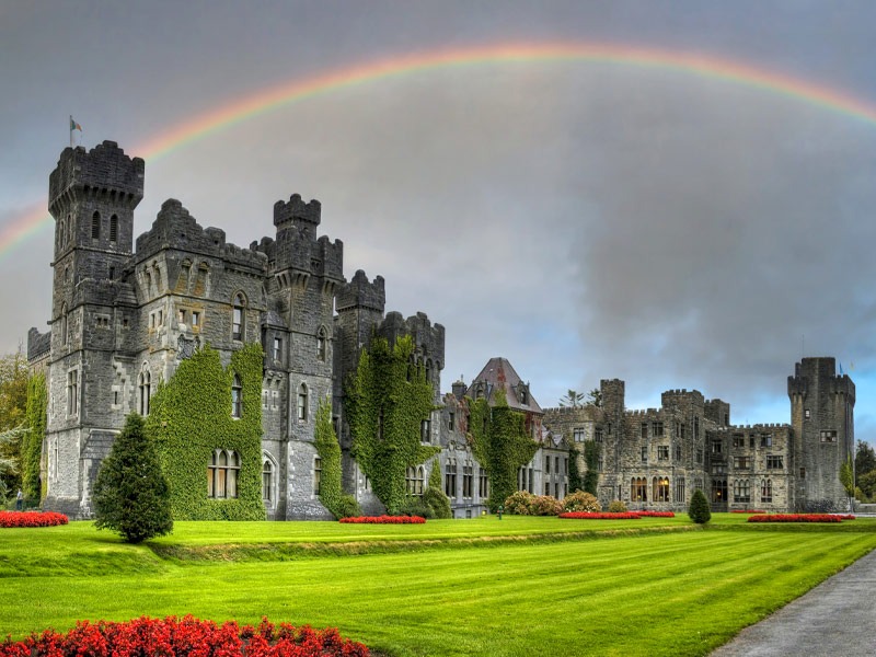 The amazing architecture of the Ashford castle in Co. Mayo with a rainbow, Ireland.